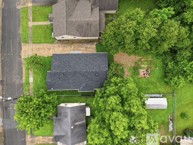 A bird's eye view of a residential area with houses and trees.