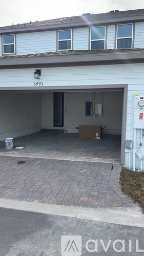 A garage with the number 6493 on the wall.
