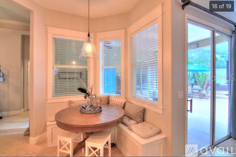 A small dining room with a round table and four chairs.