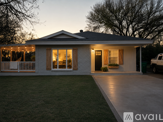 A house with a white picket fence and string lights on the porch.