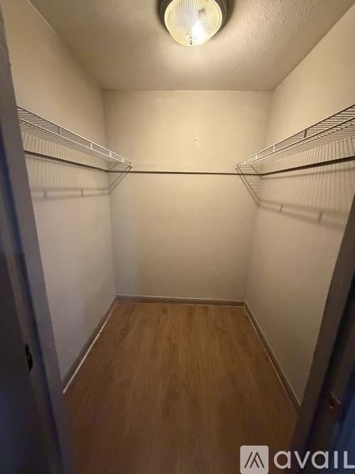 A small, empty closet with a light on.