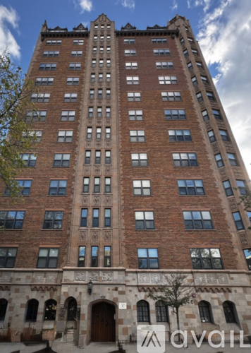 A tall red brick building with many windows.