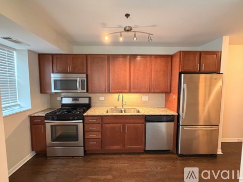 A kitchen with wooden cabinets and stainless steel appliances.