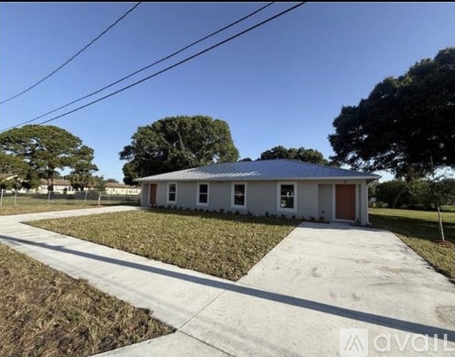 A house with a metal roof is available for sale.
