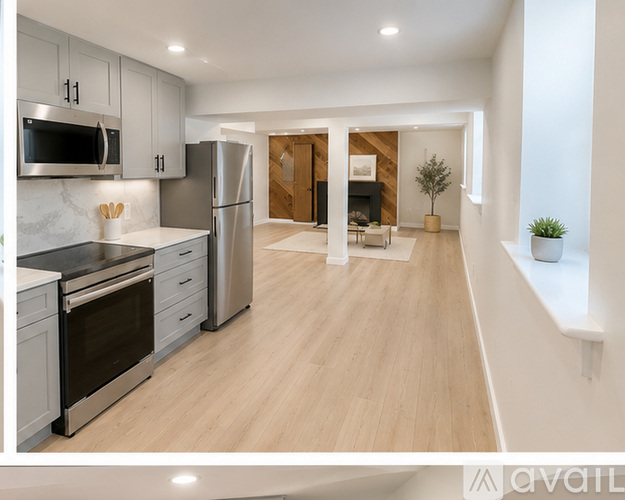 A modern kitchen with stainless steel appliances and wooden flooring.