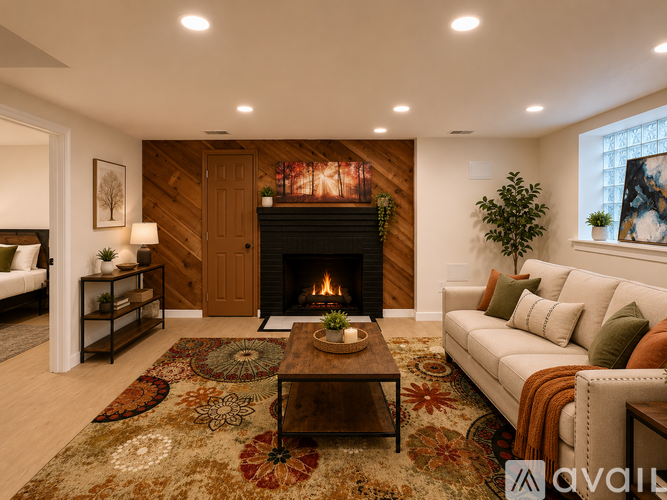 A living room with a fireplace and wooden floors.