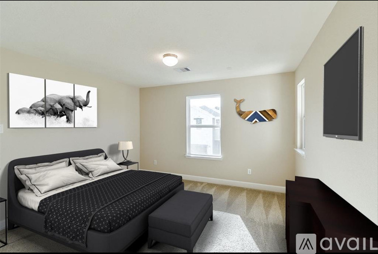 A bedroom with a large bed and a painting of an elephant on the wall.