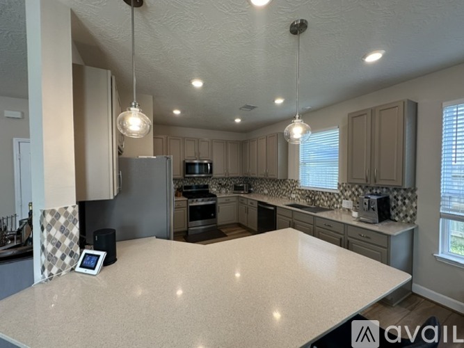 A kitchen with a table and a refrigerator.