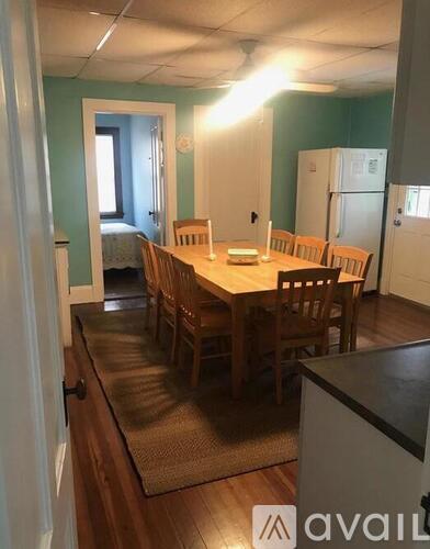 A dining room with a long table and chairs.