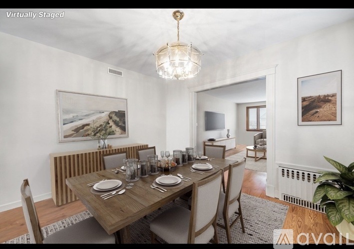 A dining room with a wooden table set for six.