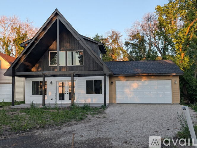 A house with a garage is for sale.