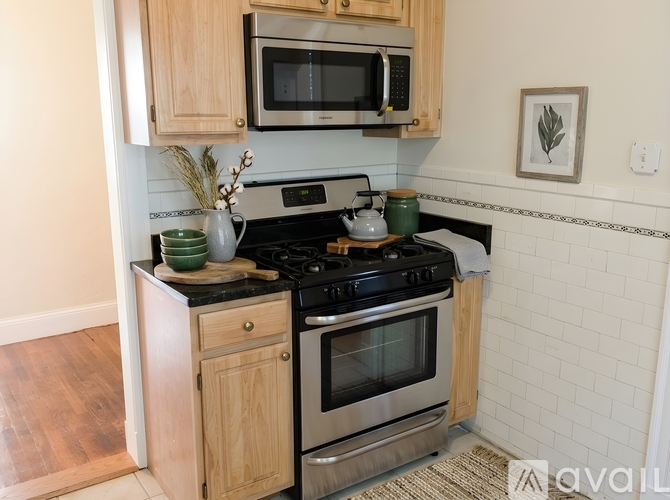 A kitchen with a stove top oven and microwave above it.