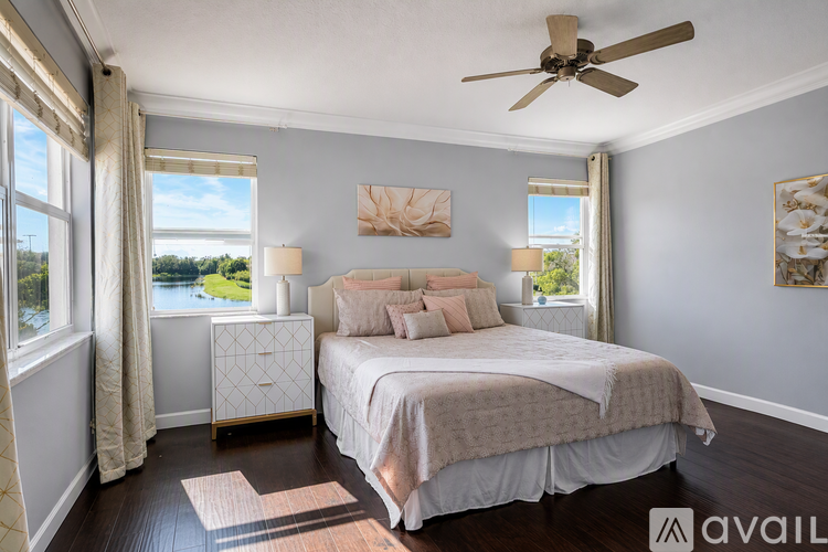 A bedroom with a large bed and a ceiling fan.