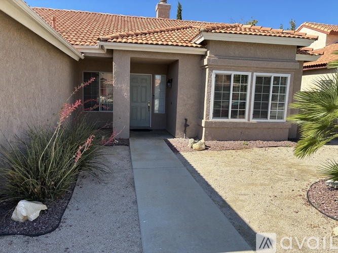 A house with a red tile roof and a grey door.