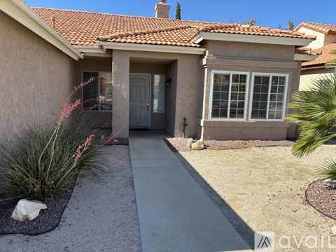 A house with a red tile roof and a grey door.