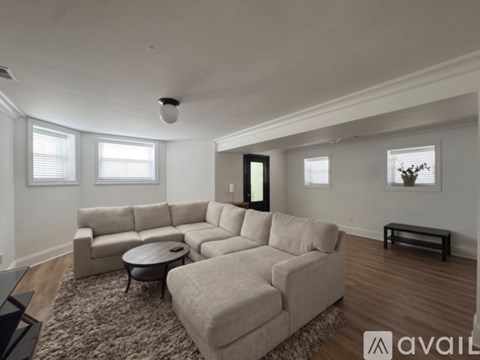 A living room with a large sectional sofa and a coffee table.
