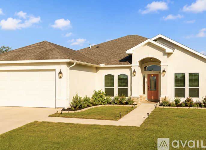 A house with a brown roof and a white garage door.