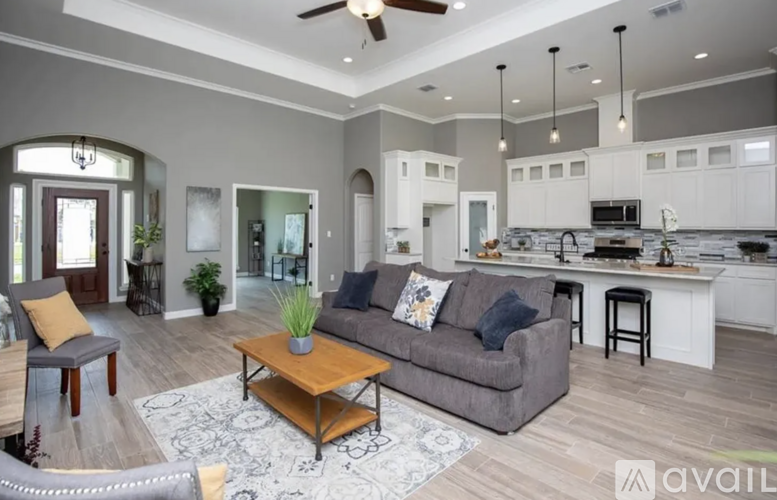 A modern living room with a grey couch and a wooden coffee table.