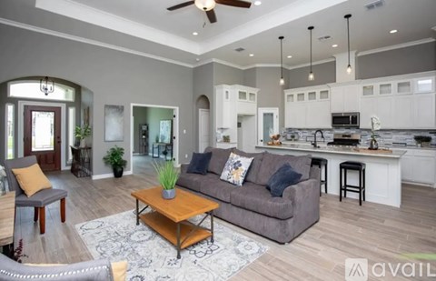A modern living room with a grey couch and a wooden coffee table.