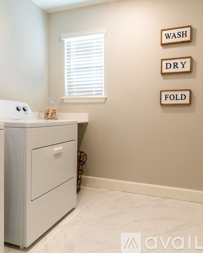 A white washer and dryer in a laundry room.