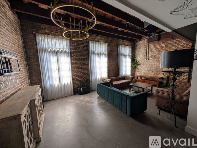 A living room with a large sofa and a wooden table.