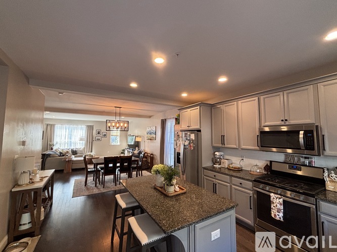 A kitchen with granite countertops and stainless steel appliances.
