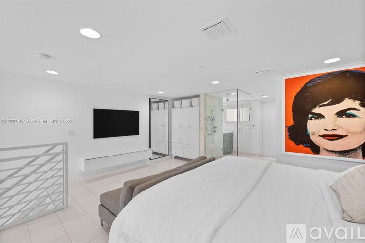 A modern living room with a large bed and a television.