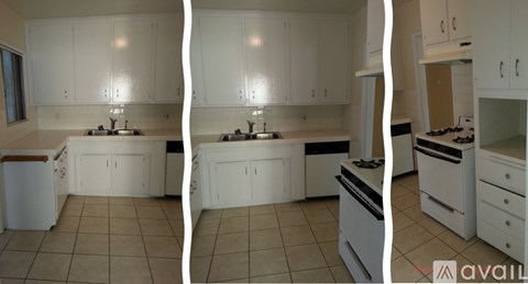A kitchen with white cabinets and appliances.