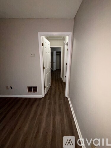 A long hallway with a door at the end.