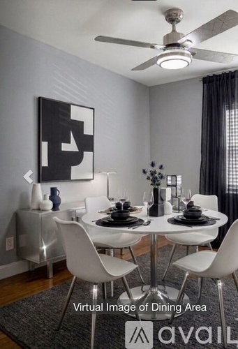 A modern dining room with a white table and chairs.