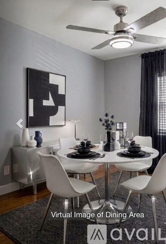 A modern dining room with a white table and chairs.