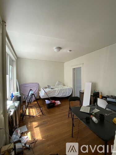 A room with a bed, desk, and chair.