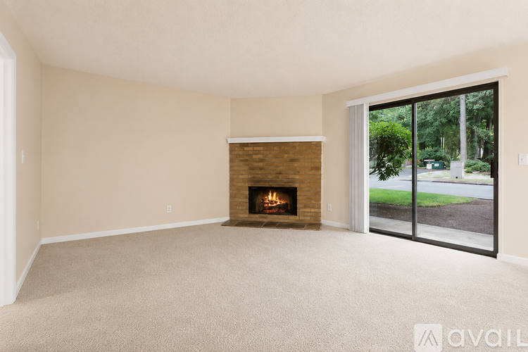 A living room with a fireplace and sliding glass doors.