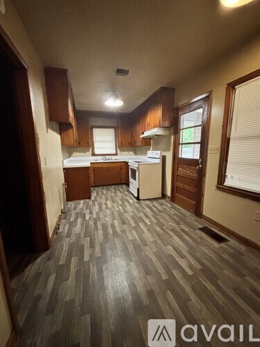 A kitchen area with a counter and a fridge.