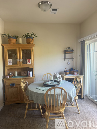 A dining room with a table set for four.