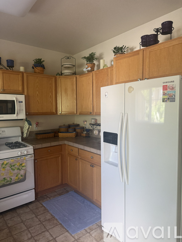 A kitchen with a white fridge and a white oven.