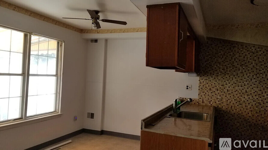 A kitchen with a sink and a window.