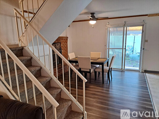 A living room with a staircase leading to the upper floor.