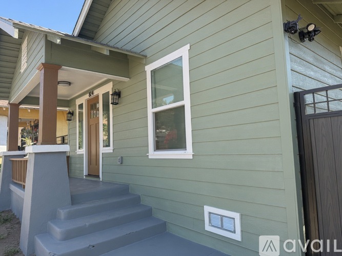 A house with a green siding and a white window.