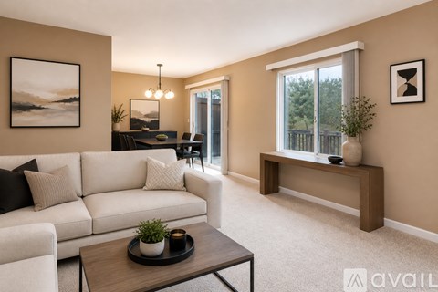 A living room with a white sofa and a wooden coffee table.