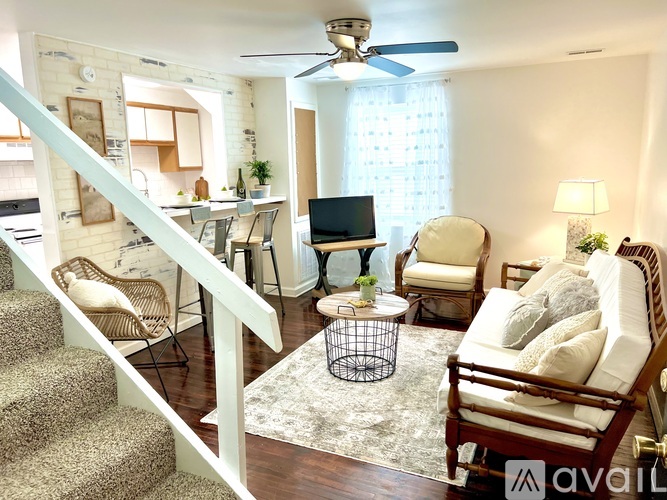 A living room with a staircase leading to the upper floor.
