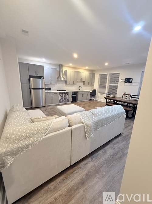 A modern kitchen with a refrigerator, oven, and sink.