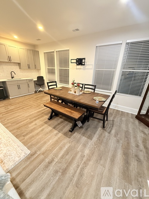 A dining room with a wooden table and chairs.