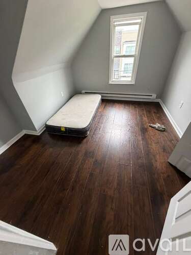 A room with wooden floors and a window.