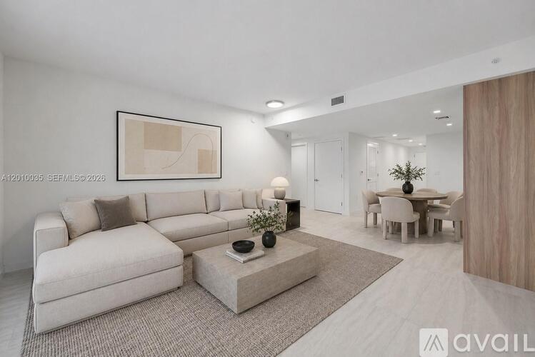 A modern living room with a large sofa and a coffee table.