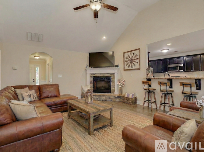 A living room with a brown leather couch and a wooden coffee table.