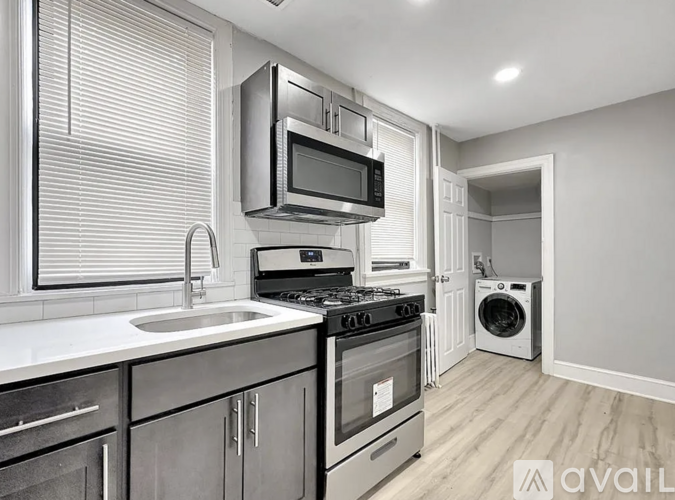 A modern kitchen with a stove, microwave, and oven.
