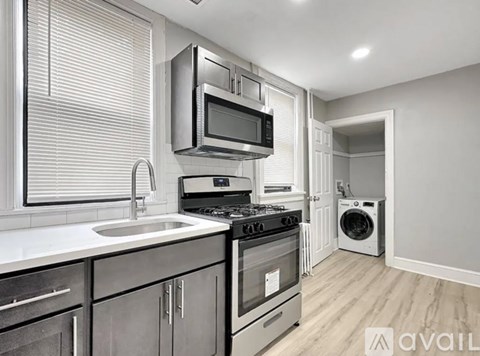 A modern kitchen with a stove, microwave, and oven.