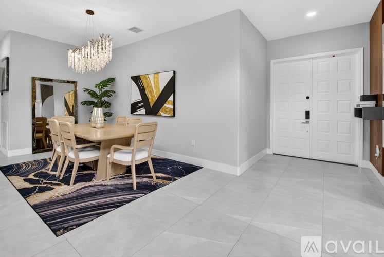 A dining room with a table set for four.