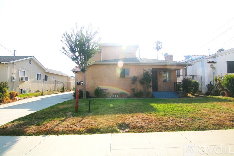 A house with a green lawn and a mailbox in front.